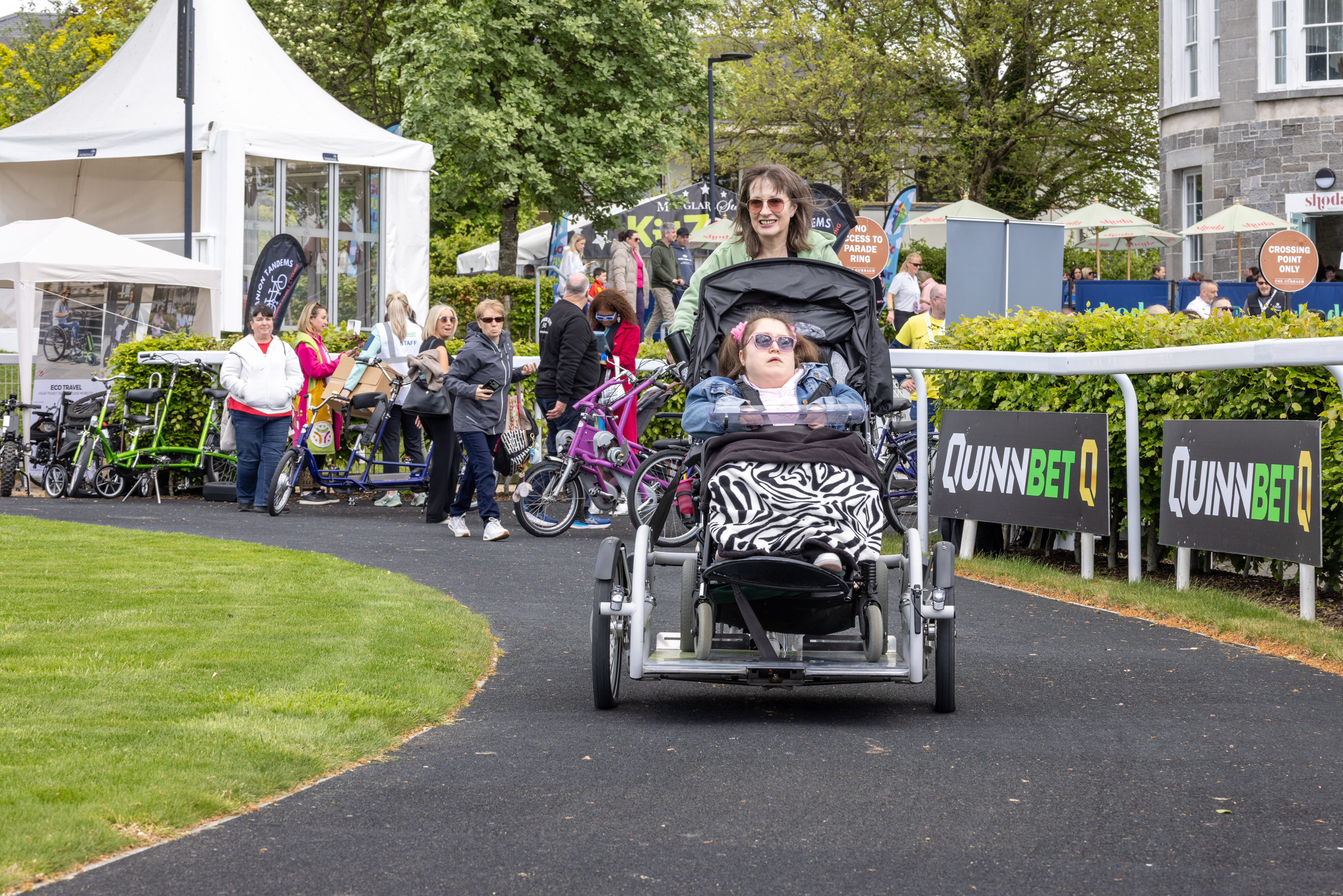 People on tandem wheelchair accessible bike.